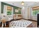 Inviting Bedroom with wood crib, accent wall, and ample natural light creating a serene and comfortable environment at 10 Wyndham Dr, Atlanta, GA 30328
