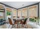 Sunlit breakfast nook with a round table, leather chairs, and large windows at 10 Wyndham Dr, Sandy Springs, GA 30328