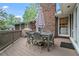 Relaxing deck with outdoor dining set featuring a brick house backdrop at 10 Wyndham Dr, Sandy Springs, GA 30328