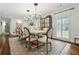 Stylish dining room featuring a chandelier, decorative cabinet, and access to the outdoors at 10 Wyndham Dr, Sandy Springs, GA 30328