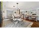 Open dining room with a table for eight, seamlessly connected to the living room and kitchen at 10 Wyndham Dr, Sandy Springs, GA 30328
