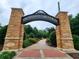 Abernathy Greenway brick entrance with manicured landscaping and winding path at 10 Wyndham Dr, Sandy Springs, GA 30328