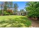 Charming front exterior featuring a large front yard and mature trees at 10 Wyndham Dr, Sandy Springs, GA 30328