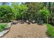 Inviting fire pit area with gravel, stone wall, and comfortable seating at 10 Wyndham Dr, Sandy Springs, GA 30328