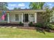 Charming front exterior featuring a welcoming front porch and landscaped yard at 10 Wyndham Dr, Sandy Springs, GA 30328