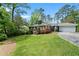Well-manicured front yard with lush lawn and mature trees enhancing curb appeal at 10 Wyndham Dr, Sandy Springs, GA 30328