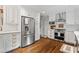 Updated kitchen featuring stainless steel appliances, white cabinets, and hardwood floors at 10 Wyndham Dr, Sandy Springs, GA 30328