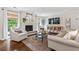 Cozy living room featuring a fireplace, comfortable seating, and ample natural light from the windows at 10 Wyndham Dr, Sandy Springs, GA 30328