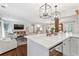Open-concept living room with modern lighting, hardwood floors, and white armchairs at 10 Wyndham Dr, Atlanta, GA 30328
