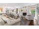Bright and airy living room with a fireplace, neutral furnishings, and an open connection to the kitchen at 10 Wyndham Dr, Sandy Springs, GA 30328