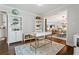 Open-concept office with built-in bookshelves and a view into the adjacent living and dining areas at 10 Wyndham Dr, Sandy Springs, GA 30328