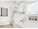 Luxurious bathroom features a glass-enclosed shower and soaking tub with elegant tile and modern fixtures at 110 Apple Blossom Ln, Fayetteville, GA 30215
