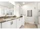 Elegant bathroom with double sinks, granite countertops, custom cabinets, and a glass-enclosed shower at 110 Apple Blossom Ln, Fayetteville, GA 30215