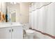 Clean bathroom featuring a white sink, toilet, and shower with a patterned curtain at 110 Apple Blossom Ln, Fayetteville, GA 30215