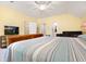 Bright bedroom with yellow walls, a ceiling fan, and large TV, creating a relaxing space at 110 Apple Blossom Ln, Fayetteville, GA 30215