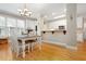 Charming dining area adjacent to kitchen featuring wood floors, white cabinetry and bright light at 110 Apple Blossom Ln, Fayetteville, GA 30215