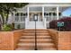 Welcoming front entrance with classic brick steps, a covered porch, and address plaque at 110 Apple Blossom Ln, Fayetteville, GA 30215