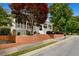 Charming home featuring a welcoming front porch, brick accents, and beautifully landscaped yard at 110 Apple Blossom Ln, Fayetteville, GA 30215