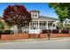 Charming home featuring a welcoming front porch, brick accents, and beautifully landscaped yard at 110 Apple Blossom Ln, Fayetteville, GA 30215