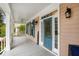 Inviting front porch featuring seating, ceiling fan, and decorative blue front door at 110 Apple Blossom Ln, Fayetteville, GA 30215