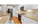 Modern kitchen with stainless steel appliances, white cabinets, granite countertops and hardwood floors at 110 Apple Blossom Ln, Fayetteville, GA 30215