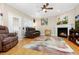 Cozy living room with hardwood floors, fireplace, and comfortable seating at 110 Apple Blossom Ln, Fayetteville, GA 30215