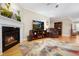 Bright living room featuring a fireplace, hardwood floors, and comfortable seating at 110 Apple Blossom Ln, Fayetteville, GA 30215