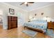 Bright main bedroom boasts hardwood floors, ceiling fan, and ensuite bathroom with a walk-in shower at 110 Apple Blossom Ln, Fayetteville, GA 30215