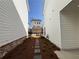 New home backyard view through pathway with partial view of garage at 146 Birch Tree Way, Cumming, GA 30040