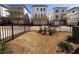 View of the backyard with three new homes and black metal fencing at 146 Birch Tree Way, Cumming, GA 30040