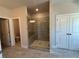 Bathroom featuring a spacious shower with tile surround and tile flooring, and a separate water closet at 146 Birch Tree Way, Cumming, GA 30040