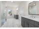 Bathroom featuring double vanities, a glass-enclosed shower, and natural light at 146 Birch Tree Way, Cumming, GA 30040