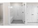 Bathroom featuring a glass-enclosed shower with white subway tiles and a gray tiled floor at 146 Birch Tree Way, Cumming, GA 30040