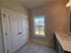 Bathroom featuring a window for natural light, a vanity and closet with double doors at 146 Birch Tree Way, Cumming, GA 30040