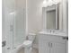 A clean bathroom features a glass walk-in shower, toilet, and vanity with double sinks and a mirror at 146 Birch Tree Way, Cumming, GA 30040