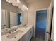 Bathroom featuring double vanity, large mirror, and access to the bedroom at 146 Birch Tree Way, Cumming, GA 30040