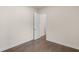 Bedroom with hardwood floors, white walls, white trim, and an open door showing the hallway at 146 Birch Tree Way, Cumming, GA 30040