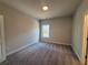 Bedroom with carpet, neutral colored walls, white trim, and a window at 146 Birch Tree Way, Cumming, GA 30040