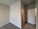 Bedroom featuring plush carpet, neutral colored walls, white trim, and access to the closet at 146 Birch Tree Way, Cumming, GA 30040