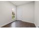 Bedroom with hardwood floors, white walls, white trim, a window, and a closet door at 146 Birch Tree Way, Cumming, GA 30040
