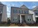 Charming gray brick two-story home with manicured lawn and classic architectural details at 146 Birch Tree Way, Cumming, GA 30040