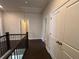 Hallway with a black wood railing, and an open doorway at 146 Birch Tree Way, Cumming, GA 30040