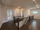 Upstairs hallway with dark wood flooring, staircase, and doorways leading to other rooms at 146 Birch Tree Way, Cumming, GA 30040
