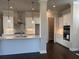 Bright kitchen features stainless appliances, white shaker cabinets and a view to the pantry at 146 Birch Tree Way, Cumming, GA 30040