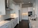 Bright kitchen features stainless appliances, white cabinets, quartz countertops and a tiled backsplash at 146 Birch Tree Way, Cumming, GA 30040