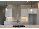 Bright kitchen features white cabinets, marble countertops, stylish backsplash, and modern pendant lighting at 146 Birch Tree Way, Cumming, GA 30040
