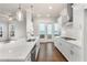 Bright kitchen with a central island, stainless steel appliances, and access to outdoor living at 146 Birch Tree Way, Cumming, GA 30040