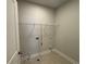 Laundry room with tile flooring, hookup connections, and metal shelving at 146 Birch Tree Way, Cumming, GA 30040