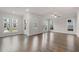 Bright living room with hardwood floors, white trim, a ceiling fan, and large windows with neighborhood views at 146 Birch Tree Way, Cumming, GA 30040