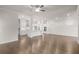 An open-concept living room featuring hardwood floors, white walls, an eat-in kitchen with modern appliances at 146 Birch Tree Way, Cumming, GA 30040
